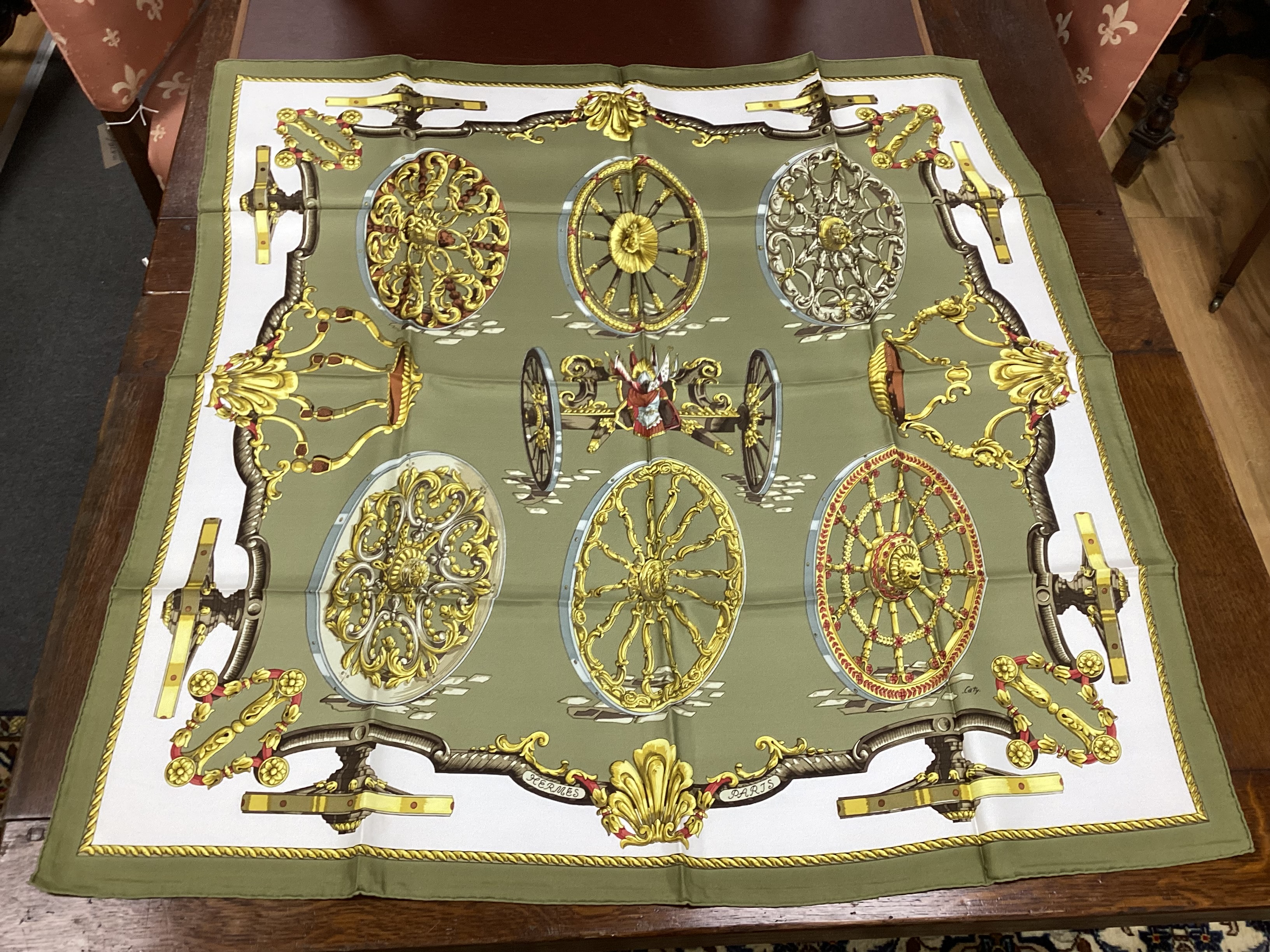 Four vintage Hermes silk scarves comprising Cosmos, Bride de Cour, Roues de Canon and a Cuivreries example retailed by Harrods
